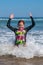 Young girl in surf at Makorori Beach, near Gisborne, New Zealand