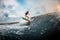 Young girl surfing on a wakeboard in the river near forest