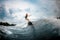 Young girl surfs on a wakeboard in the river near forest