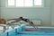 Young girl swimmer, that jumping and diving into indoor sport swimming pool.