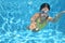 Young girl swimmer swimming under water in pool and has fun, teenager diving underwater, family vacation, sport and fitness