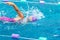 Young girl swimmer working on her freestyle swim at a local pool