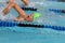 Young Girl swimming freestyle in race