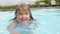 Young Girl Swimming In Outdoor Pool