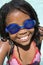 Young girl in swimming pool wearing goggles