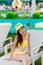 Young girl in a swimsuit on a shelf by the pool