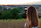 Young Girl taking photo of Sunset with her Smartphone