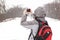 Young girl taking pictures at the landscapes in winter day