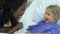 Young Girl Talking To Female Nurse In Intensive Care Unit