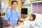 Young Girl Talking To Male Nurse In Hospital Room