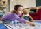 Young Girl and Teddy Playing Snakes and Ladders