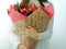 Young girl, teen girl holding bouquet of pink, red roses.