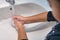 Young girl thoroughly washing hands at home. Coronavirus prevention against virus outbreak