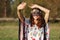 The young girl with a tiara on her head locked hands from the sun Outdoors