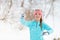 Young girl tosses snowball
