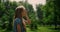 Young girl touch face in green park closeup. Child scratching nose on sunlight.