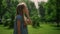 Young girl touch face in green park closeup. Child scratching nose on sunlight.