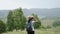 Young girl tourist with backpack travelling in the mountains, wearing hat.