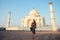 Young girl tourist looking to the Taj Mahal in Agra, India . concept of culture, tourism and religion