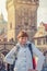 Young girl tourist with white jacket look at camera and smile at Charles Bridge Karluv Most in Prague city historical