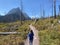 A young girl on a trail hiking on three falls trail with Saint Mary Lake below in Montana, USA.