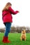 A young girl trains her dog