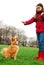 A young girl trains her dog at a park