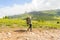 Young girl travel with big green backpack and fishing rod in it