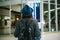 Young girl traveler with a backpack in a hat looks at the information board at the airport. Getting information about