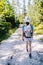 Young girl traveler with backpack while hiking