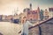 Young girl traveler with checked shirt looking at camera and smile, medieval wooden ship and embankment of Motlawa river