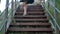 A young girl traveler climbs the stairs in the mountainous terrain.