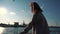 A young girl traveler enjoys a sea view during a sea walk on a ship.