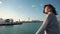 A young girl traveler enjoys a sea view during a sea walk on a ship.