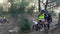 young girl on a trials motorcycle prepares to jump onto a steep mountain