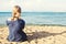 Young girl on tropical beach vacation, female back against sea, sand and sky