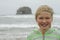 Young girl by twin rocks on Rockaway beach Oregon