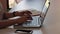 Young Girl type on the keyboard on the laptop in office environment