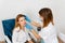 A young girl undergoes a medical examination in a cosmetology clinic.