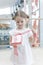 Young girl unwrapping ribbon on present