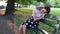 Young girl upset sitting on a Park bench. Problems of teenagers.