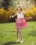 Young girl using hula hoop in a park