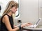 Young girl using laptop computer on train