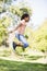 Young girl using skipping rope outdoors smiling