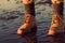 Young girl walking on a beach at low tide, feet detail