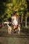 Young girl walking down the street with two dogs.