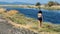 Young girl walking towards flamingos in the water