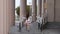 Young girl walking up ramp with pillars in background