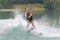 Young girl water skiing on slalom course