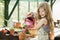 Young girl watering plants in greenhouse